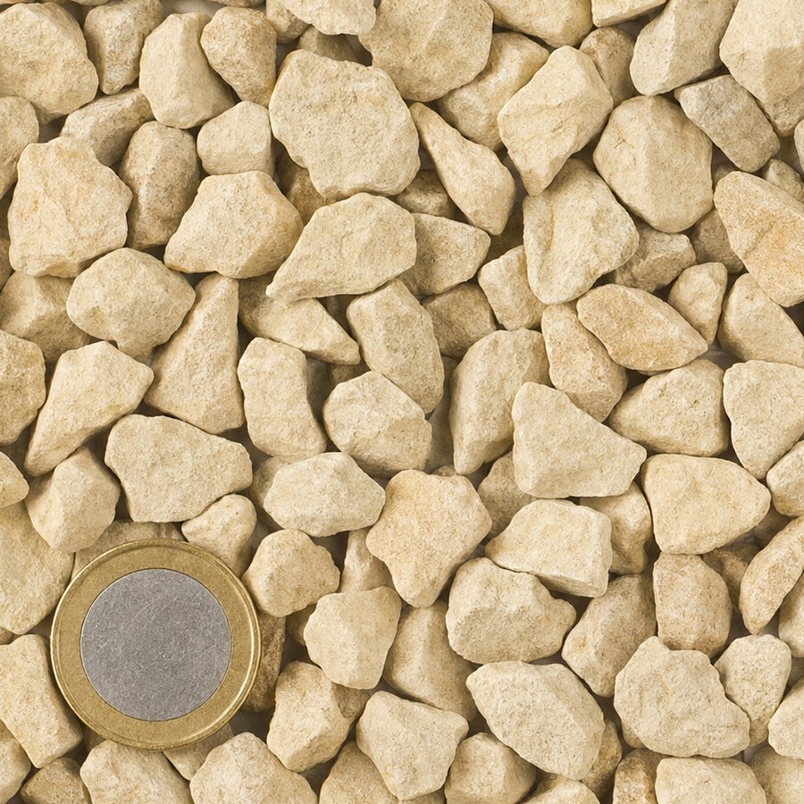 Jura 8/16 mm van bovenaf, op schaal naast een munt van 1 euro (gezichtsveld 9 bij 9 cm)